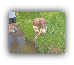 student by a stream